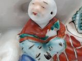 a figurine of a man sitting on a horse
