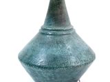 a green table lamp with a white shade on it