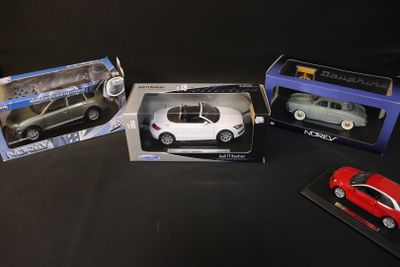 four different models of cars are in boxes on a black surface