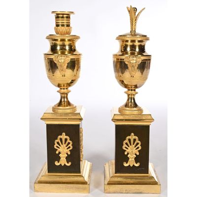 pair of antique brass and black vases on stands