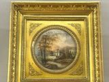 an old picture frame with a painting of a landscape on it