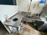 a small kitchen with a sink and a stove in it