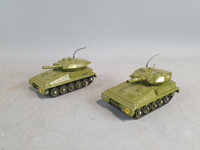 two toy tanks sitting side by side on a white surface