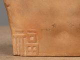 a close up of a clay pot with a design on it