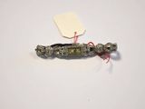a small metal object with a tag attached to it