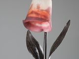 a lamp that is sitting on a table with a flower on it