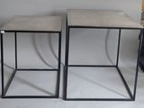 pair of concrete side tables with black metal bases