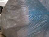 a large plastic bag sitting on top of a cardboard box