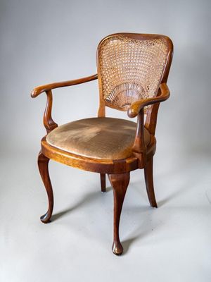 an image of a chair with a cane back and a seat made of wood