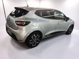 the rear end of a silver car in a white room