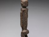 an image of a statue of a person standing on top of a rock