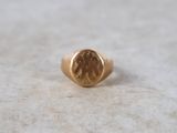 an image of a gold signet ring with a man ' s face on it