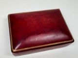 a red box with gold trim on a white surface