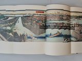an open book with a picture of a bridge in the background