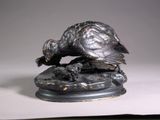 a statue of a bird that is on top of a table