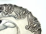 a silver plate with a horse on it on a table