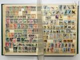 an open book with stamps on it and a pair of scissors in front of it