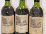 three bottles of wine sitting on top of a white table