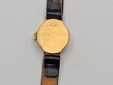 an image of a gold watch with a black leather band