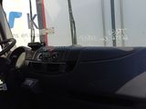 a truck that is driving down the road with its driver