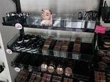 a lot of makeup products on the shelves in the store