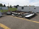 a lot of junk in the parking lot next to a building