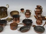 a lot of copper pots and pans on the table