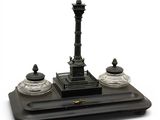 a small statue of a clock on top of a table