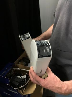 someone is holding a cell phone in their hand in a box