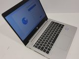 a laptop that is open on a white table