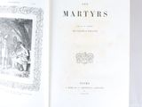 an open book with a picture of a man and a woman in a garden