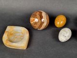 several different types of stones are arranged on a black surface