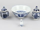 a blue and white bowl and two small vases