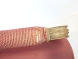 a piece of wood sticking out of a piece of cloth