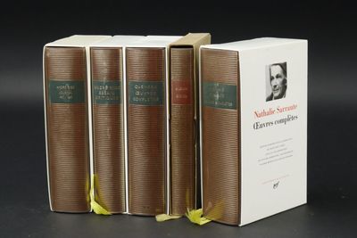 three books are stacked on top of each other on a table