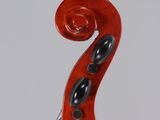 an old violin with a red bow and black spots on the back