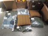a lot of pillows and other items on the floor