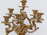 a gold colored candelab with many candles on it