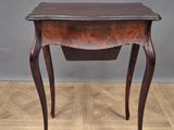 an old wooden table with a drawer on top of it on a parquet floor