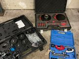 three tools in a case on the floor next to each other