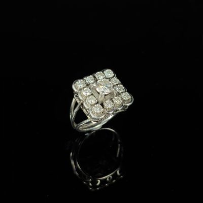a close up of a diamond ring on a black surface