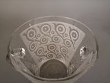 a glass bowl that has a coin in it