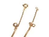 the gold chain earrings are attached to a chain with pearls