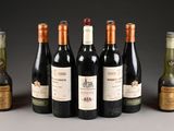 several bottles of wine sitting next to each other on a table