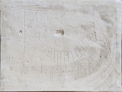 a stone plaque with a drawing on it on a wall