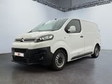 the white van is parked in the large room of the building
