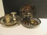 three silver plated dishes and cups on a white table