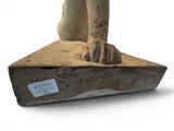 a statue of a cat sitting on top of a box