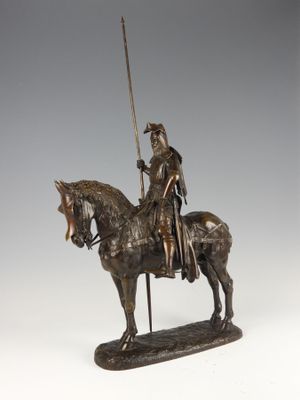 bronze statue of a man on a horse with a sword