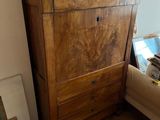 a wooden cabinet with a ship on top of it